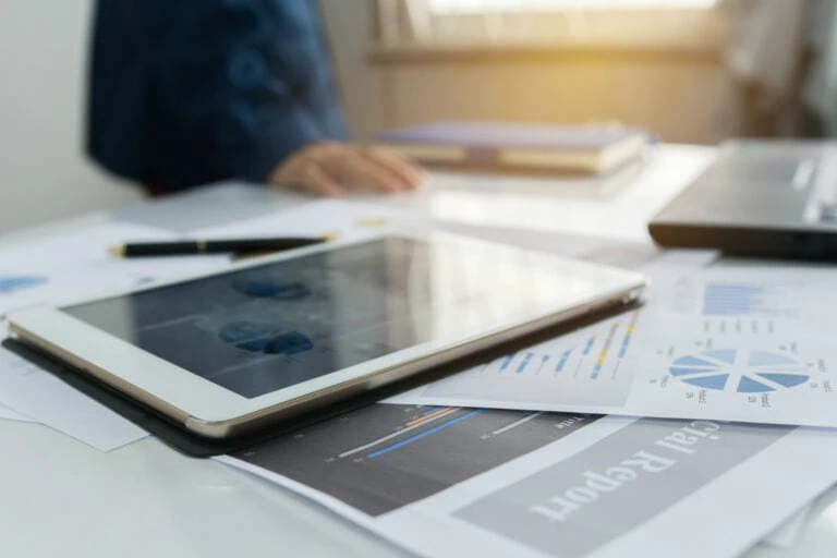 Digital tablet displaying financial data and charts.